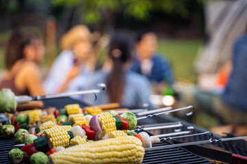 Group of diverse friend having outdoors camping party together in tent. 