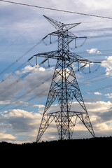 Silhouette of electric power towers during dusk in countryside of Brazil