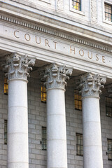 Facade of federal courthouse with towering columns.  - obrazy, fototapety, plakaty