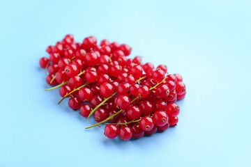 Heap of ripe red currant on color background