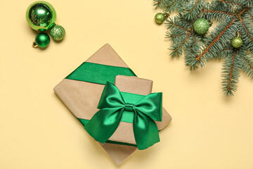 Composition with beautiful Christmas gifts, balls and fir branches on color background