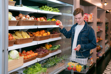 An European man buy a fruit and vegetable from refrigerator cold