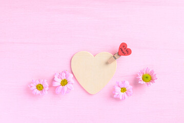 Chrysanthemum flower with heart shape on pink background, Love Valentine concept