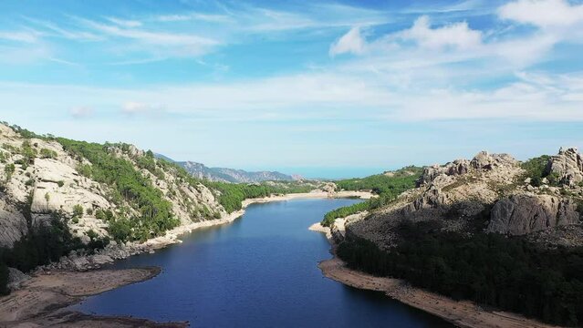 The Lac de lOspedale in the middle of the green countryside, in Europe, in France, in Corsica, towards Ajaccio, by the Mediterranean Sea, in summer, on a sunny day.