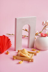 Fortune cookie with podiums and Chinese symbols on pink background