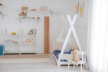 Fototapeta na wymiar Stylish interior of children's room with baby bed
