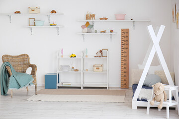 Stylish interior of children's room with baby bed