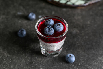 Shot with delicious chia seed pudding and blueberry on black table