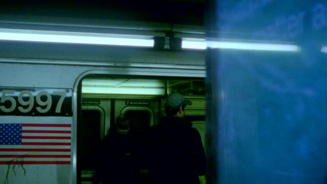 16mm film of man getting on New York City subway train.