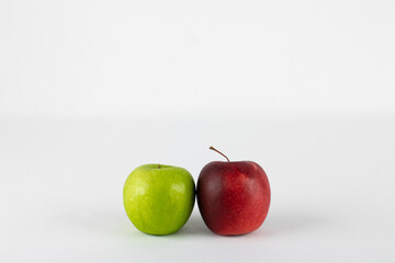 Red and green apple on white background