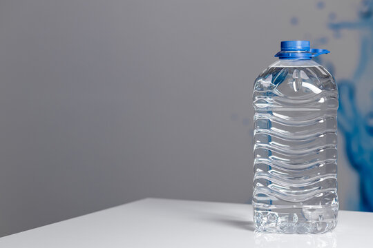 Plastic Water Bottle On The Wooden Table, Sunny Day