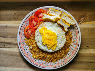 (Nasi Goreng) Indonesian Fried Rice on a wooden table