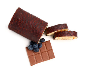 Pieces of tasty sponge cake roll, chocolate and blueberry on white background