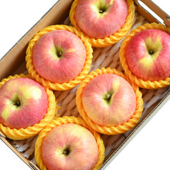 beautiful pink apple in the box on white background