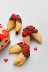 Fortune cookies with gift on grey background, closeup. Valentine's Day celebration