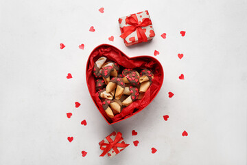 Box with fortune cookies, gifts and hearts on white background. Valentine's Day celebration