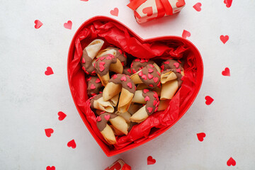 Box with fortune cookies and hearts on white background. Valentine's Day celebration