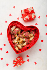 Box with fortune cookies, gifts and hearts on white background. Valentine's Day celebration