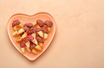 Plate with fortune cookies on beige background. Valentine's Day celebration