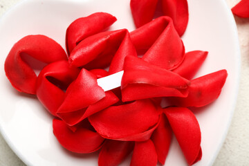 Plate with red fortune cookies on light background, closeup. Valentine's Day celebration