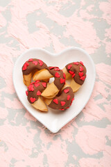 Plate with fortune cookies on grunge background. Valentine's Day celebration