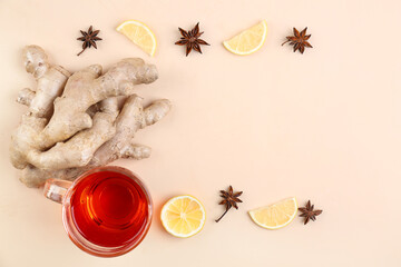 Ginger roots, cup of black tea, lemon slices and anise on beige background