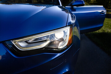 Obraz na płótnie Canvas Headlight of a blue car.