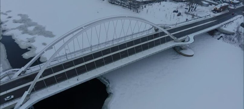 Aerial View Of Man Running Across Snow Covered Lowry Bridge In NE Minneapolis