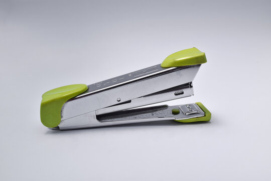 Office stationary green stapler isolated on white background