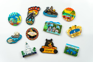 Mane travel magnets on the white fridge. Travel and vacation concept. Souvenirs from America.