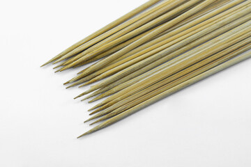 pile of wooden skewers isolated on a white background