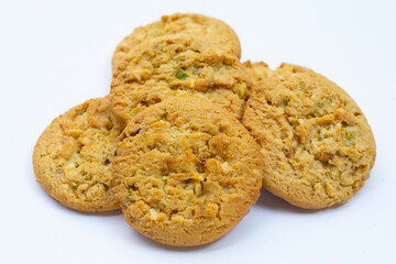 Pistachio and almond cookies on white background.