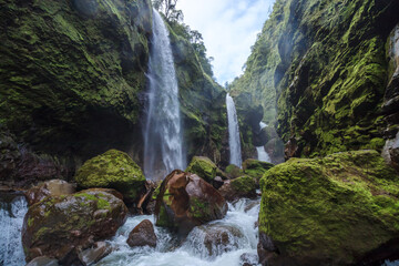 scenic landscape of waterfalls falling into the riverbed in the middle of the paradisiacal tropical jungle