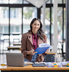 young business Asian woman holding document file at workplace office 
