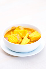 Curry with bamboo shoots and fish pieces.