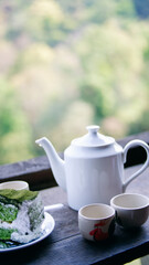 tea leaves,Tea plantation field scenery,Cup of hot tea,hot herbal tea with mint in a glass bowl