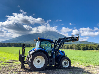 A tractor stretching in front of Mt. Yotei