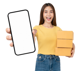 Smiling beautiful Asian woman holding cardboard boxes and hands show smartphone mockup of blank screen on PNG transparent background. Take your screen to put on advertising. Concept delivery online.