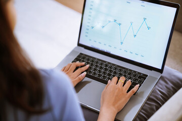 Business woman working from home. work online on laptop. Asian businesswoman working on sofa online business with social distancing laptop online meeting