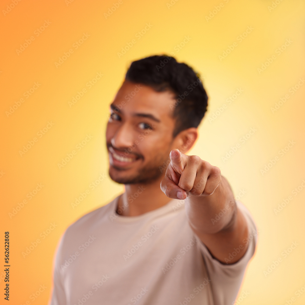 Poster Man, point and happy portrait of a person with a hand sign with orange studio background. Smile, isolated and model with blur mock up space and hands and finger gesture zoom smiling alone with beard
