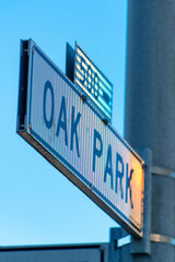 Black and white sign that says oak park in the historic districts of downtown san francisco california on cement light pole