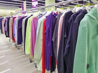 Hangers with clothing and accessories. Sale of clothing. second-hand.