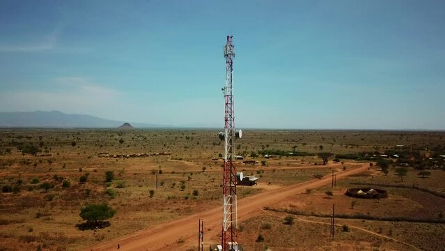 Shot of drone circling a telecommunications antenna near a remote village in Karamoja, Uganda, Africa.