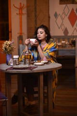 Young woman drink tea in cafe winter 