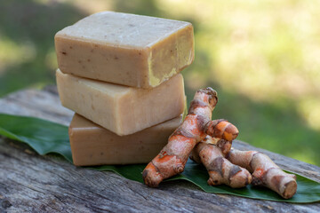 Turmeric,bar soap on wooden background. spa concept.