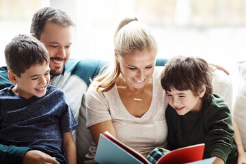 Mom, dad and kids reading books on sofa for storytelling time with smile in happy family home. Love, learning and couple with children, book and fantasy story on couch, growth and child development.