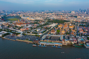 Aerial view Day to Night of Chao Phraya River with Royal Grand Palace and Emerald Buddha Temple Landmark of Bangkok, Thailand. Amazing Drone Footage over the City skyline in twilight.