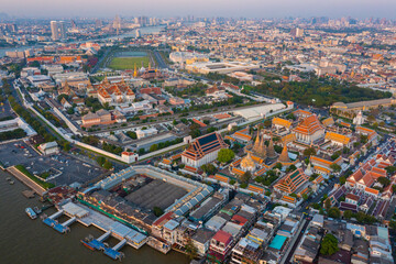 Aerial view Day to Night of Chao Phraya River with Royal Grand Palace and Emerald Buddha Temple Landmark of Bangkok, Thailand. Amazing Drone Footage over the City skyline in twilight.