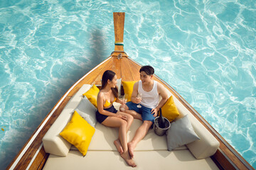 Asian couple lover travel and relax in they honeymoon trip on the wooded boat - 562637230