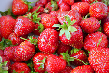 Fresh many tasty organic strawberries, strawberries with strawberry leaf, closeup, background